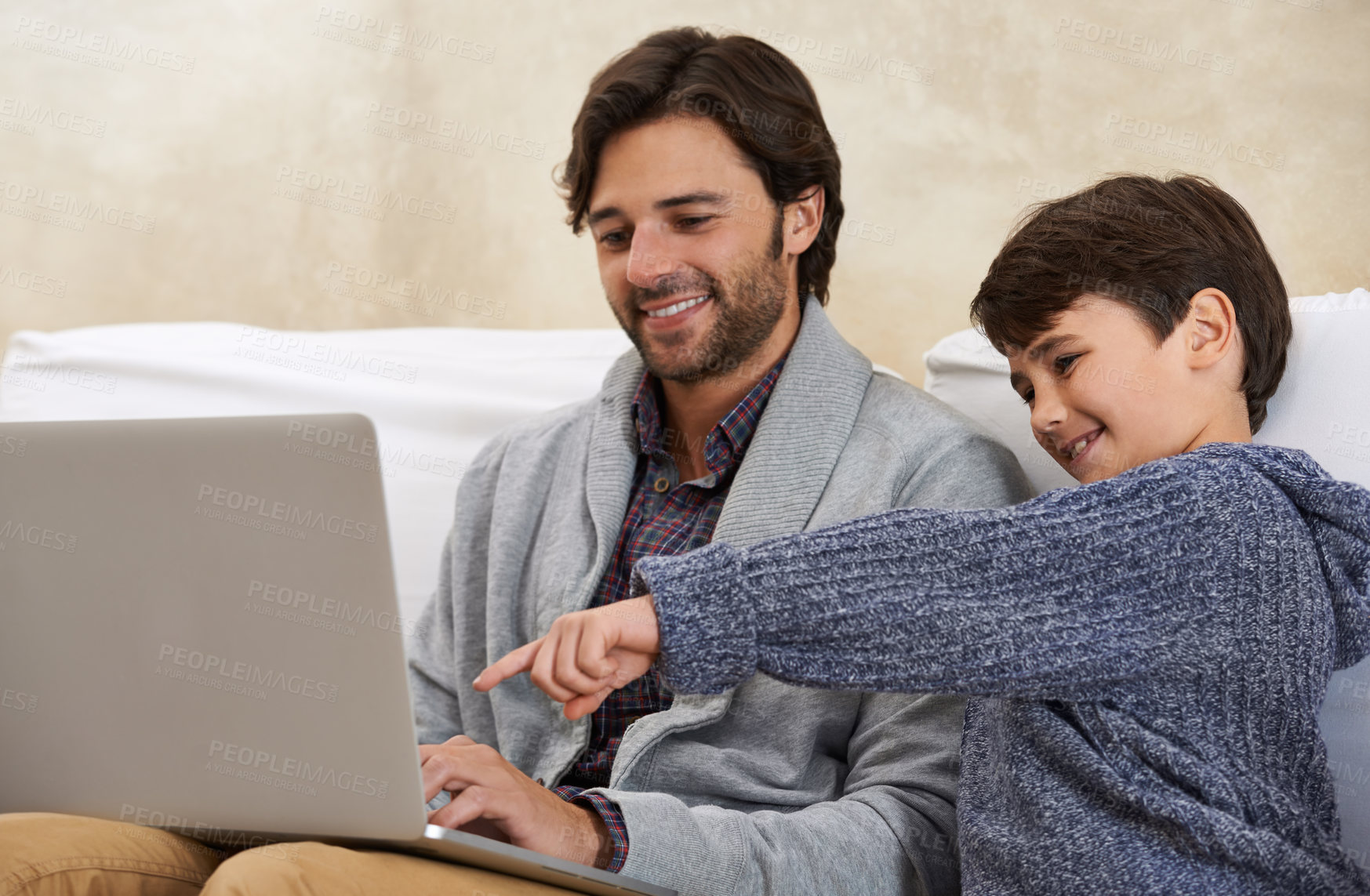 Buy stock photo Father, son and laptop on sofa with smile, pointing and watching movie for bonding in living room of home. Family, man and child with technology, happy or relax on couch in lounge of house with love 