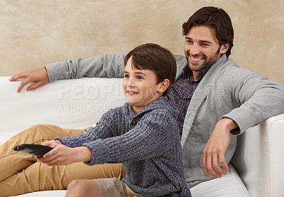 Buy stock photo Relax, TV and father and child on sofa with remote for bonding, smile and fun in living room. Family, parents and dad with young son for cartoon, watching movies and entertainment in home