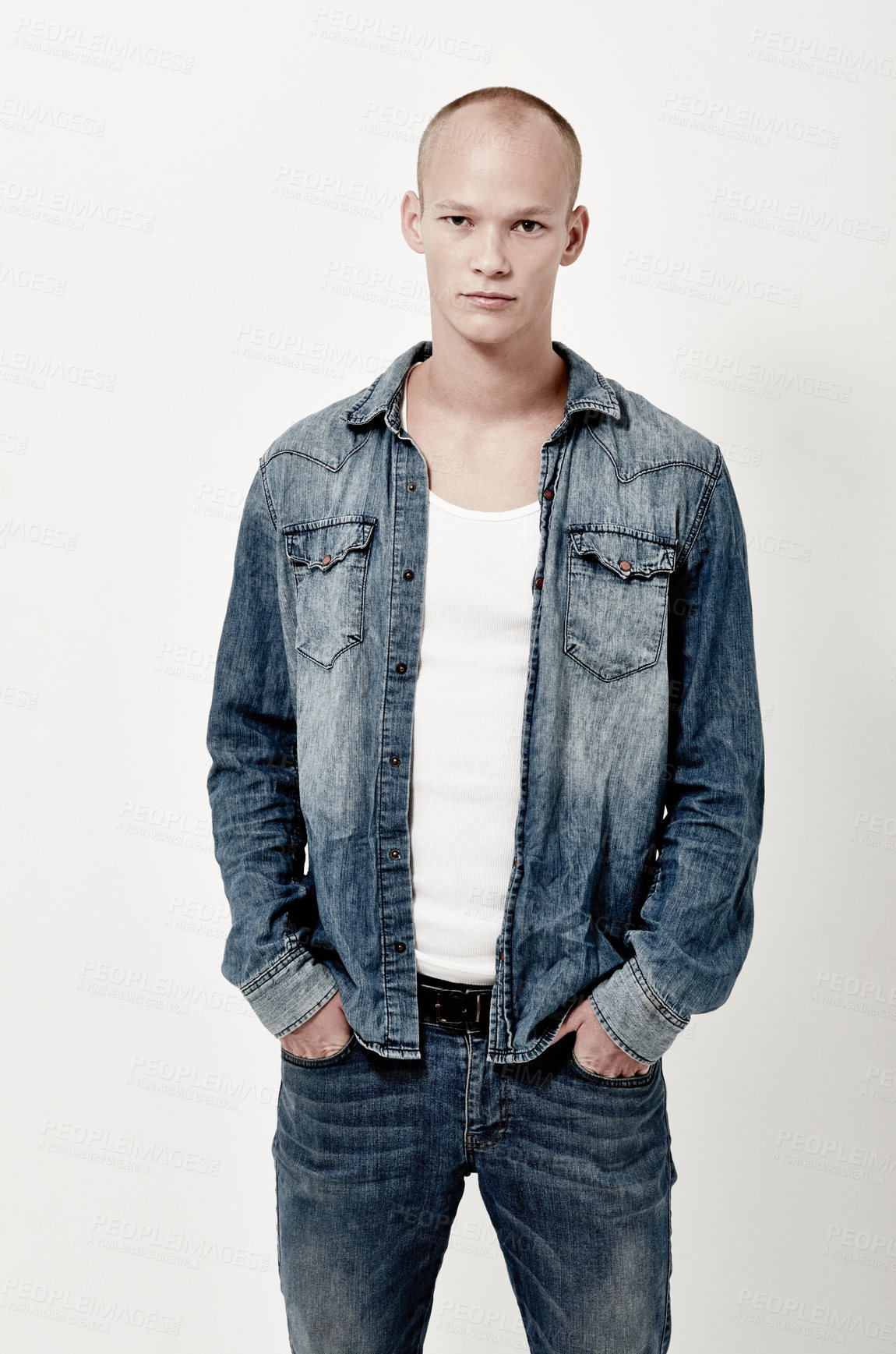 Buy stock photo Serious, man and fashion portrait in studio with jeans for stylish, trendy and clothes with jacket. Male person, white background and denim outfit with tshirt for gen z, aesthetic and cool look  
