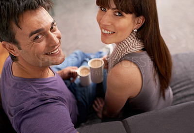 Buy stock photo Couple, love and coffee on sofa in lounge, marriage and together in apartment to relax in home. Partners, happiness and comfortable in couch of living room at house, relationship and smile of lovers
