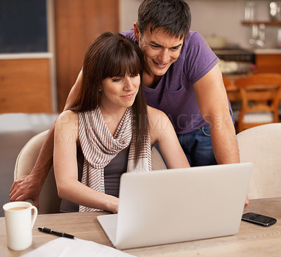 Buy stock photo Couple, happy and laptop in kitchen with paper for budget, smile and coffee on table by pen. Partners, love and payment of apartment rent with technology, tax and online with connection from internet