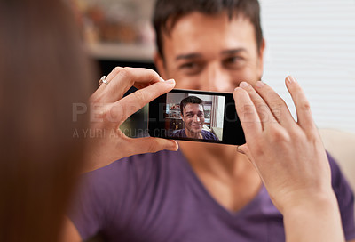 Buy stock photo Phone screen, photography and couple in house happy, bonding and having fun together. Smartphone, profile picture and woman with photo, app or romantic memory of husband while chilling in living room