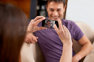 Buy stock photo Photography, phone screen and couple in house happy, bonding and having fun together. Smartphone, profile picture and woman with photo, app or romantic memory of husband while chilling in living room