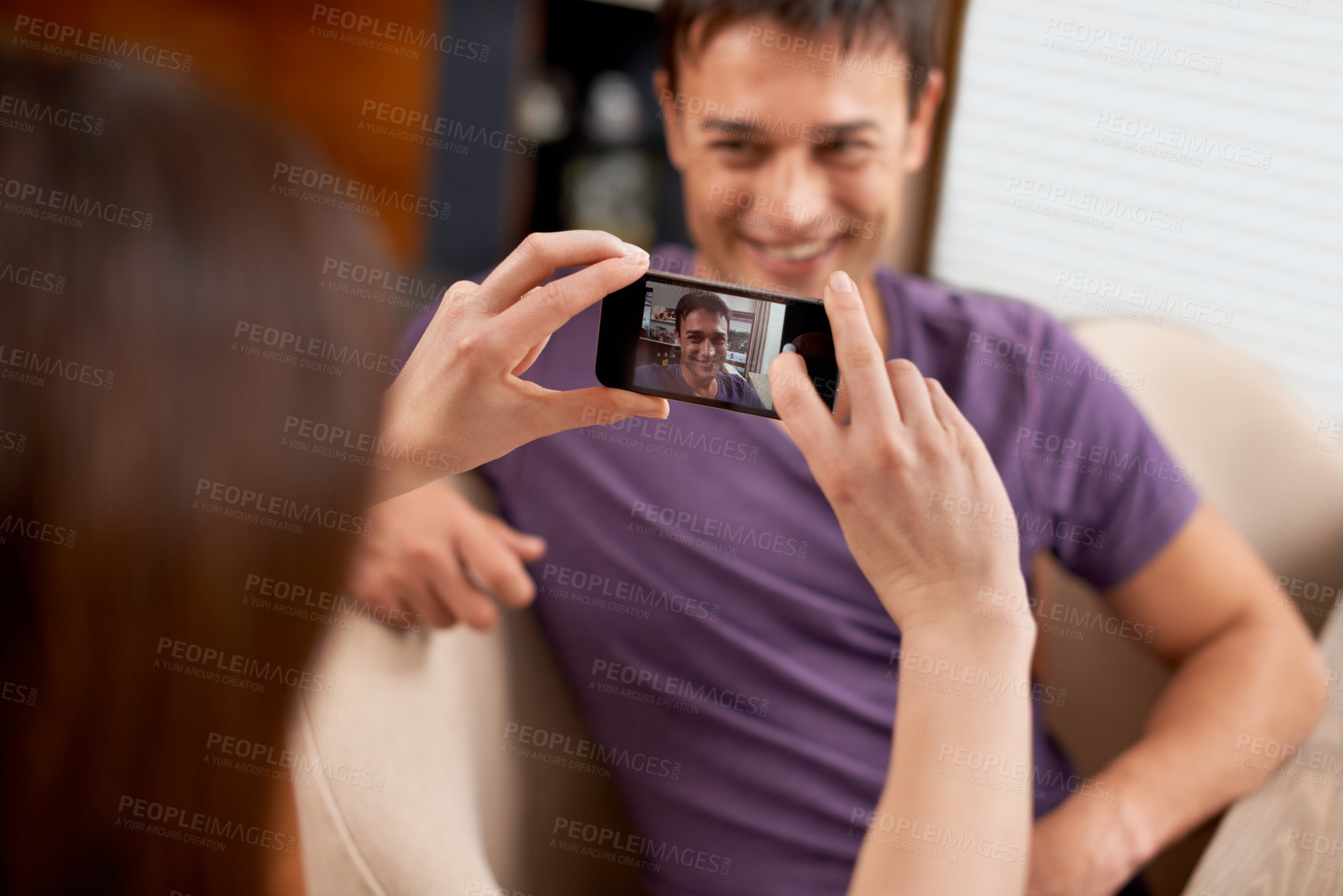 Buy stock photo Photography, phone screen and couple in house happy, bonding and having fun together. Smartphone, profile picture and woman with photo, app or romantic memory of husband while chilling in living room