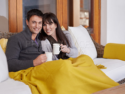 Buy stock photo Portrait, love and happy couple relax on a sofa with trust support or bonding with coffee or blanket at home. Smile, face or people in living room with security, safety and chilling together with tea