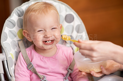 Buy stock photo Happy, baby and laughing from feeding in high chair at home in the morning ready for eating food. Youth, funny and smile of a infant with development and laughter in house with fun and joy of a child