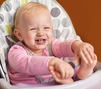 Buy stock photo Happy, baby and laughing in high chair at home in the morning ready for eating food. Youth, funny and smile of a infant with development and laughter in a house with feet playing and joy of a child