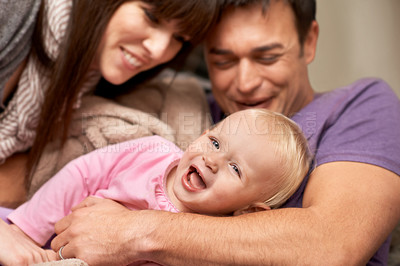Buy stock photo Love, hug and baby with parents in a house for playing, tickle or games while bonding in laughter. Happy family, face and kid with funny people in living room with support, trust or child development