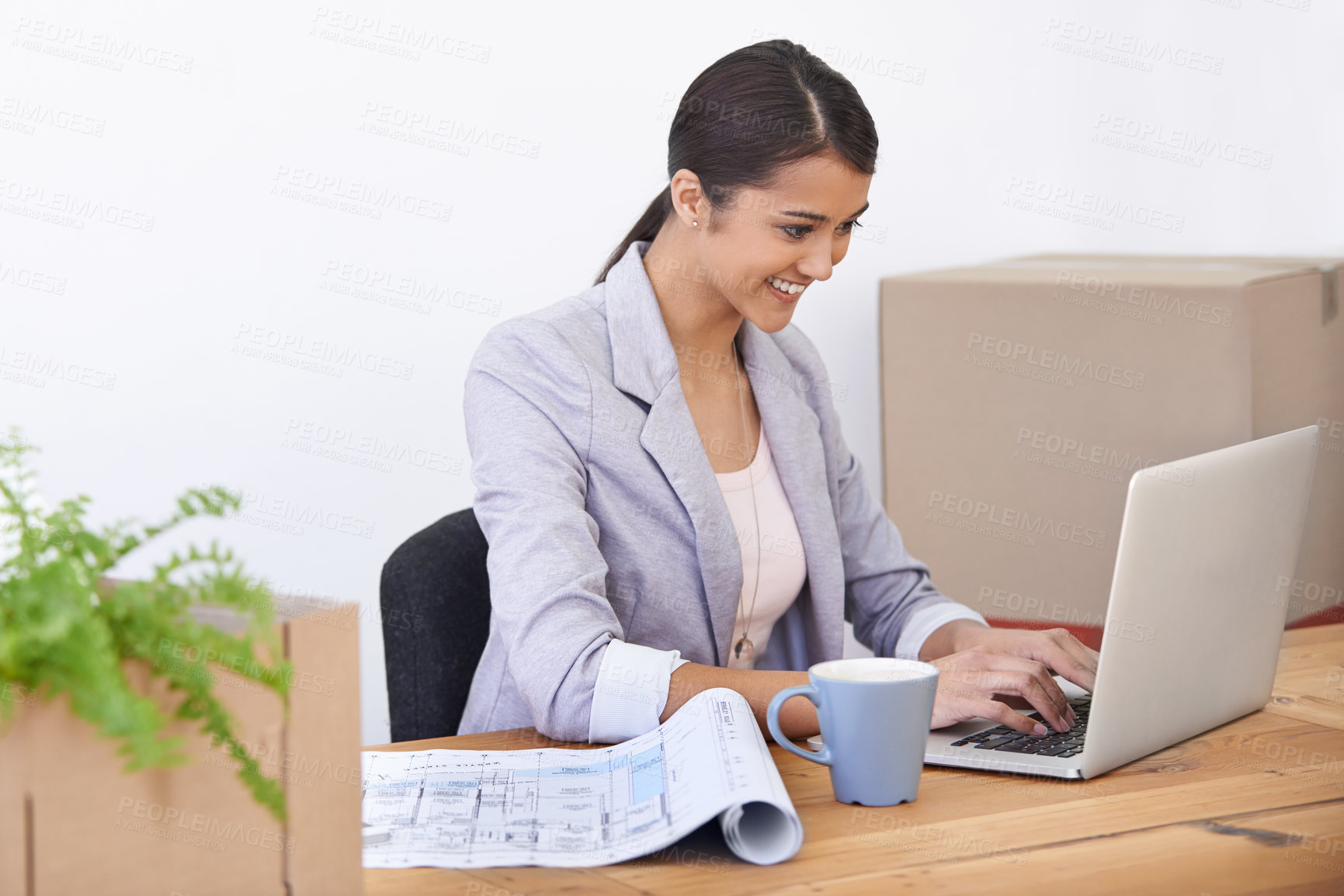 Buy stock photo Woman, architecture and happy by laptop at startup with blueprint, typing or new beginning in modern office. Person, computer and entrepreneur with smile at small business for planning in workplace