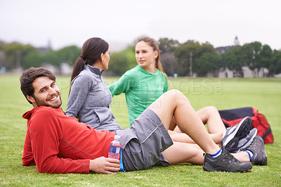 Buy stock photo Friends, relax and exercise on field for portrait, training and happy for fitness with health in summer. People, man and women with wellness with smile, body and workout group on lawn in Australia