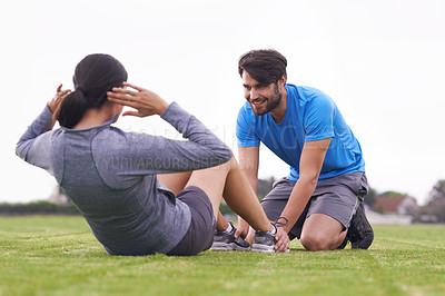 Buy stock photo Personal trainer, man and woman with sit ups on grass for fitness, training and helping hand in summer. People, support and motivation for abdomen exercise with workout on park lawn in Australia