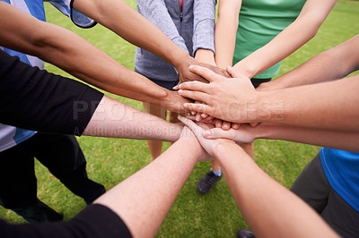 Buy stock photo Cropped shot of a sports team with their hands in a huddle