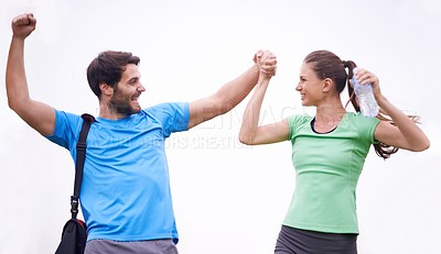 Buy stock photo Happy couple, fitness and holding hands in celebration for teamwork, success or winning on a white background. Excited man and woman with smile for workout achievement, exercise or victory
