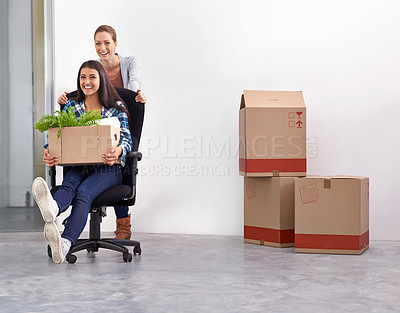Buy stock photo Shot of two female entrepreneurs moving into a new office