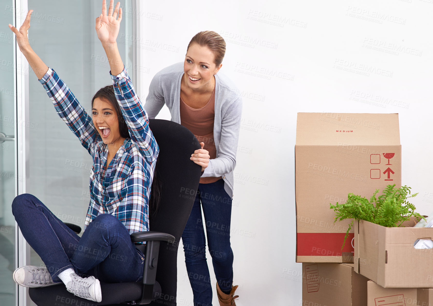 Buy stock photo Shot of two female entrepreneurs moving into a new office