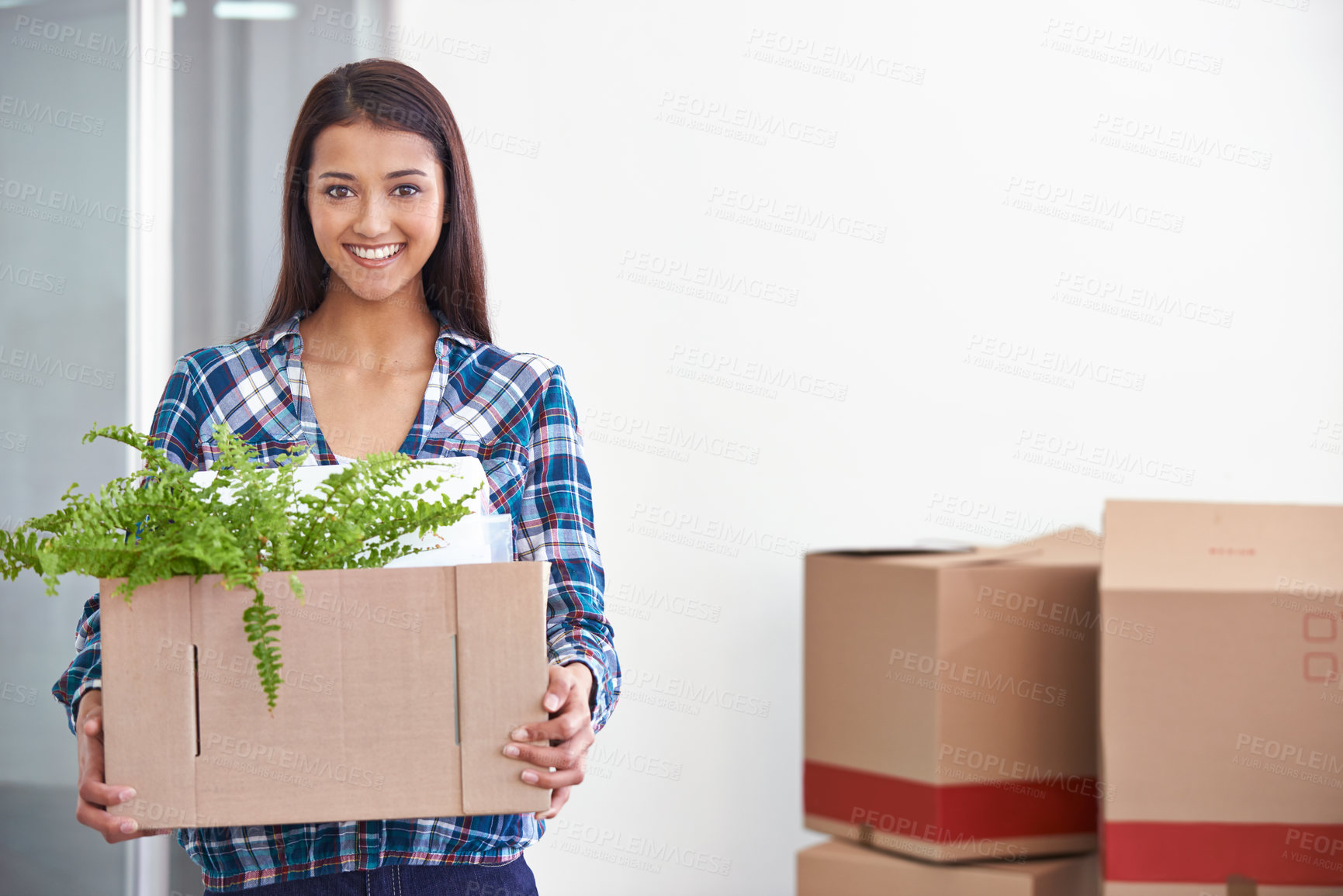 Buy stock photo A young woman holding a box