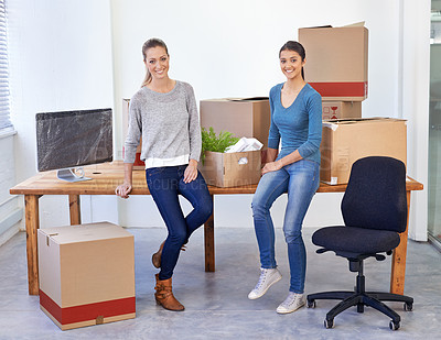 Buy stock photo Full-length shot of two female entrepreneurs moving into a new office