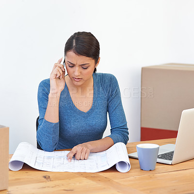 Buy stock photo Woman, phone and call with blueprint for planning, communication and scheduling in home office. Female architect, point and concentration with smartphone, laptop and paper for project management