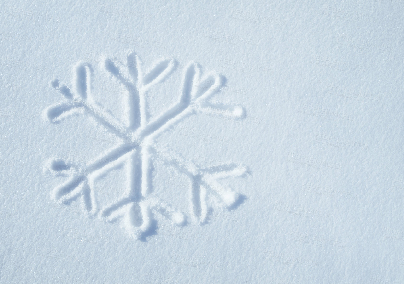 Buy stock photo Above shot of a snowflake shape or pattern drawn in the snow during an icy cold winter with copyspace. The first sign of winter. The weather is changing. The cold season has arrived. First snowfall