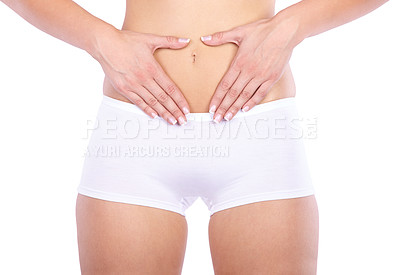 Buy stock photo Cropped studio shot of a woman measuring her waistline isolated on white