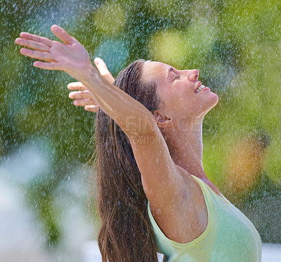 Buy stock photo Side view of a young woman standing happily in the rain