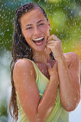 Buy stock photo Woman, rain and portrait with laughing from summer climate, water and weather outdoor in park. Happy, travel and female person with funny joke from raindrops on holiday and vacation with trip and joy