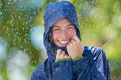 Buy stock photo Woman, rain and portrait with a smile from winter climate, water and weather outdoor in a park. Happy, travel and female person with jacket for cold on holiday and vacation with raincoat and joy