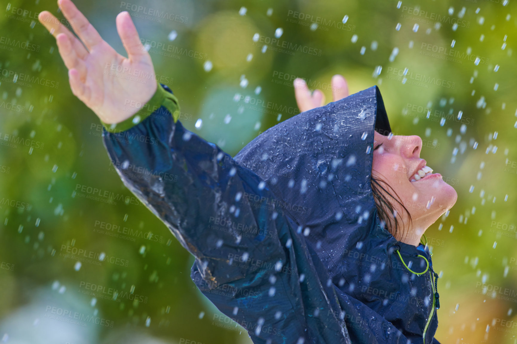 Buy stock photo Woman, rain and freedom with a smile from winter climate, water and weather outdoor in a park. Happy, travel and female person with jacket for cold on holiday and vacation with raincoat and joy