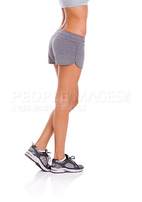Buy stock photo Woman, athlete and legs in studio with wellness for exercise, workout and healthy body with training shoes. Model, person and confidence with sportswear and shorts for fitness on white background