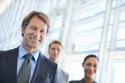 Buy stock photo Mature businessman, portrait and pride in leadership, office and confidence in management. Business people, teamwork and collaboration or support in workplace, smiling and ceo at startup company