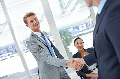 Buy stock photo Shaking hands, partnership and business men in office for agreement, deal or collaboration. Smile, meeting and professional people with handshake for onboarding or hiring welcome in workplace.