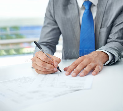 Buy stock photo Cropped shot of a businessman signing a document