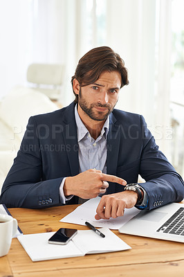 Buy stock photo A handsome businessman pointing to his watch while at his desk
