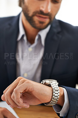 Buy stock photo Cropped shot of a businessman checking the time on his watch