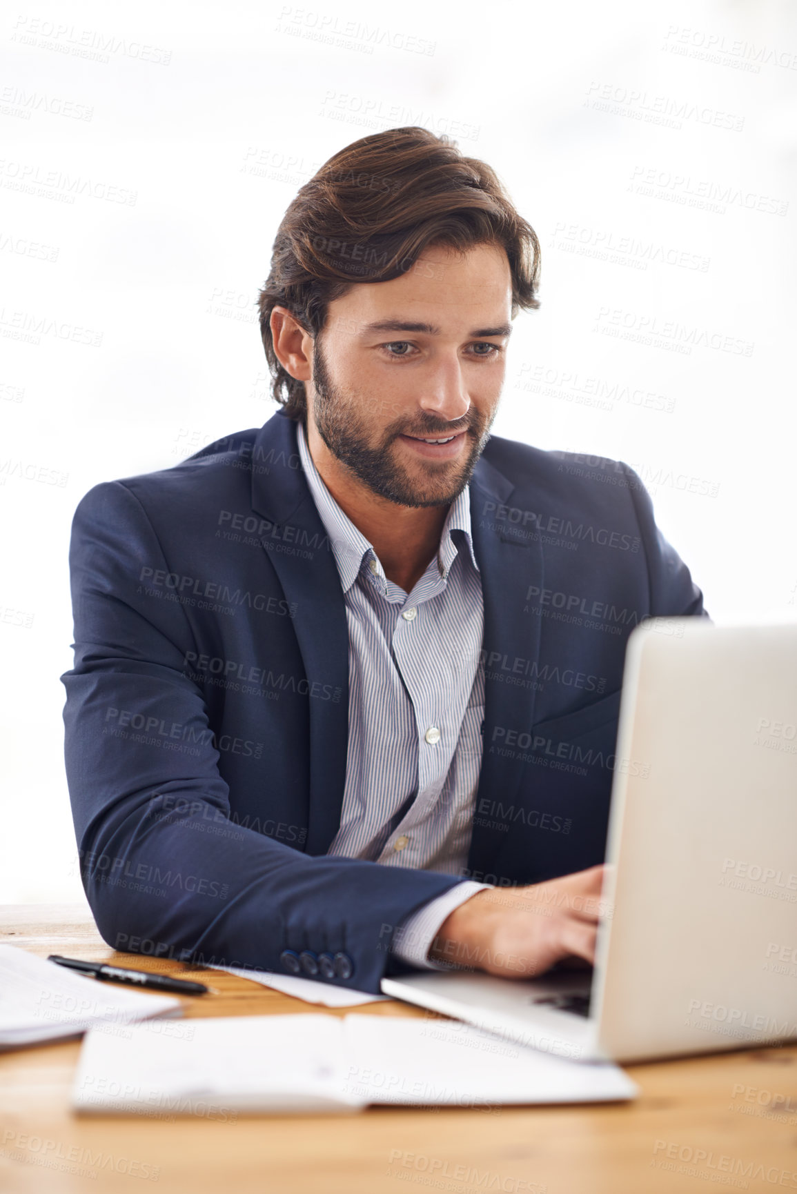Buy stock photo A handsome businessman  typing on his laptop