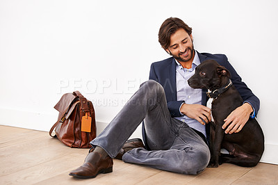 Buy stock photo A handsome businessman sitting alongside his dog