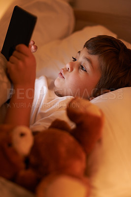 Buy stock photo Boy, tablet and bedroom with night, connection and technology for social media or learning. Child, bed and connectivity for knowledge, elearning and internet surfing at home or house with touchscreen