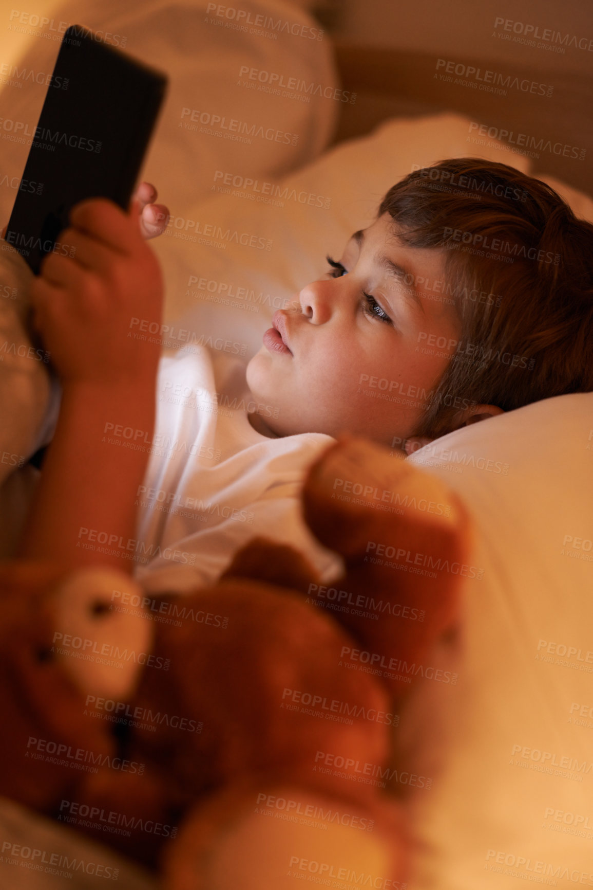 Buy stock photo Boy, tablet and bedroom with night, connection and technology for social media or learning. Child, bed and connectivity for knowledge, elearning and internet surfing at home or house with touchscreen