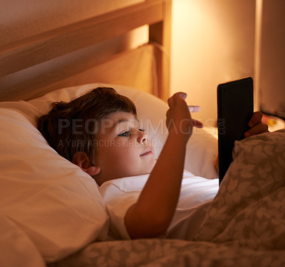 Buy stock photo Child, tablet and bedroom with night, smile and technology for social media or learning. Boy, bed and connectivity for knowledge, growth and elearning or internet surfing at home with touchscreen