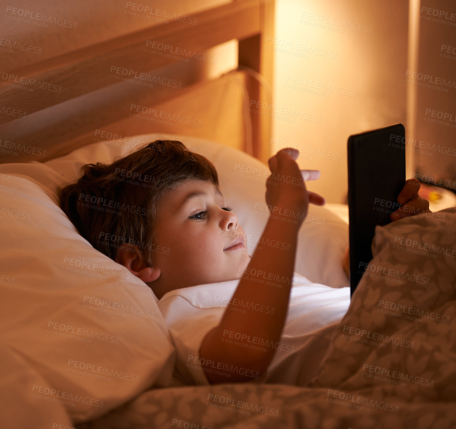 Buy stock photo Child, tablet and bedroom with night, smile and technology for social media or learning. Boy, bed and connectivity for knowledge, growth and elearning or internet surfing at home with touchscreen