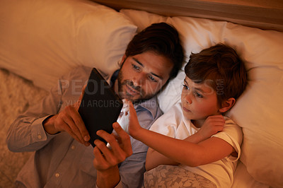 Buy stock photo Bedroom, father and son with tablet, evening and family with ebook and connection with social media. Dad, home and boy with tech or bedtime with lights or bonding together with hobby or storytelling