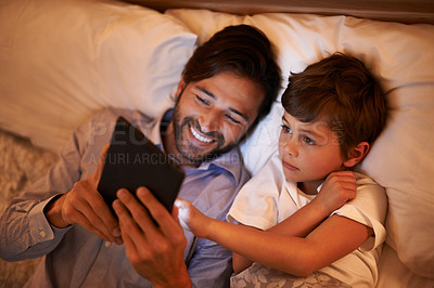 Buy stock photo Bedroom, father and son with tablet, night and family with ebook and connection with social media. Dad, house and boy with technology and bedtime story with lights and bonding together with hobby