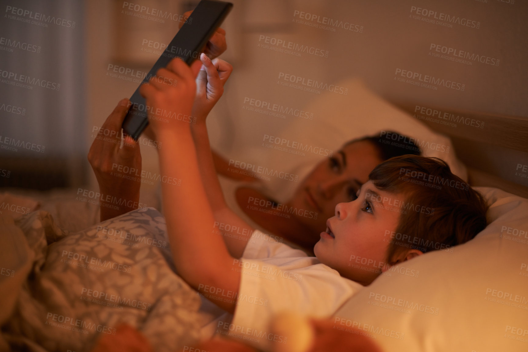 Buy stock photo Bedroom, mother and son with tablet, night and family with ebook and connection with social media. Mama, home and boy with technology or bedtime story with lights or bonding together with digital app