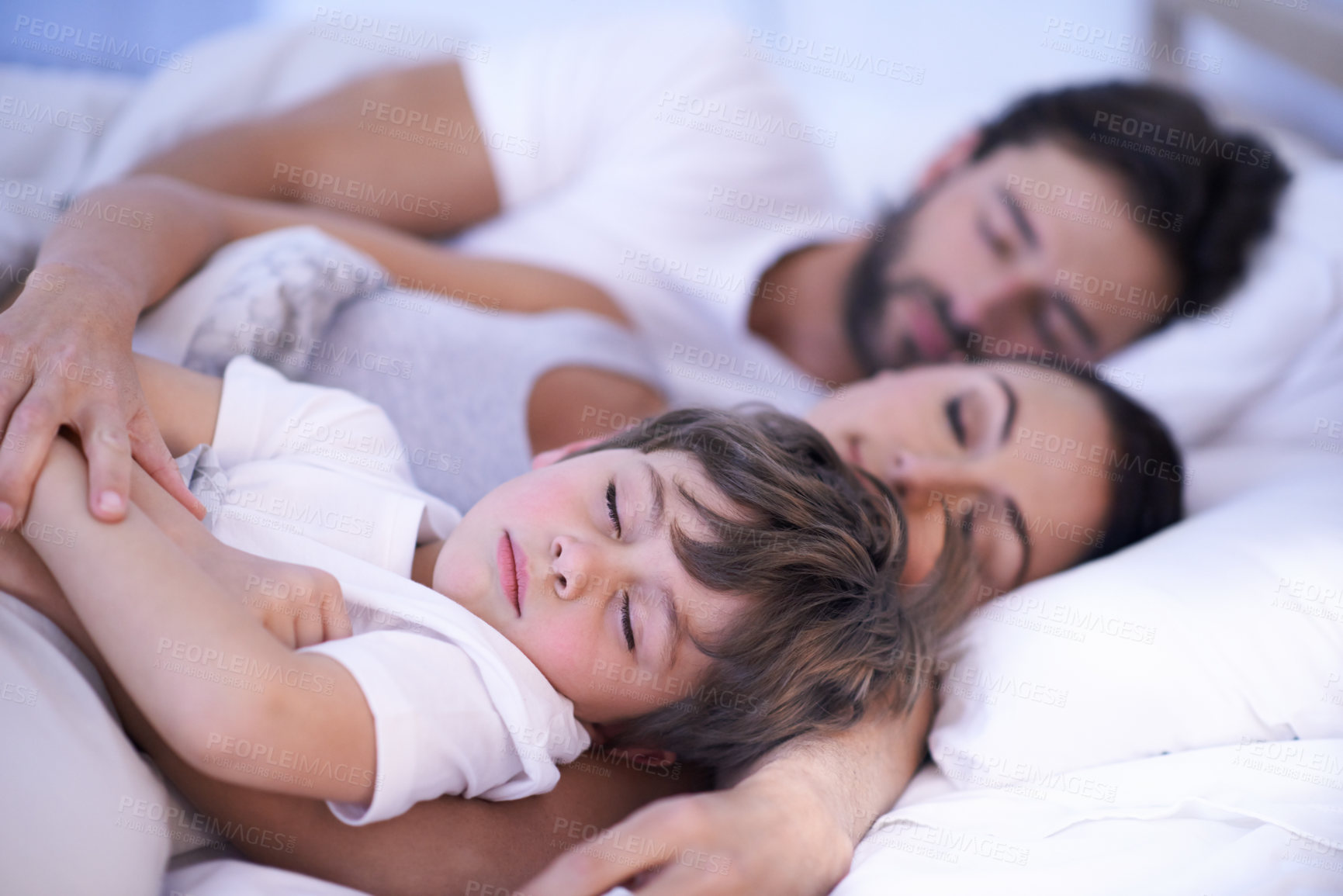Buy stock photo Parents, boy and sleeping in bedroom, home and embrace for rest, peace and quiet with bonding. Father, mother and child in bed with blanket for fatigue, burnout and exhausted in night at family house