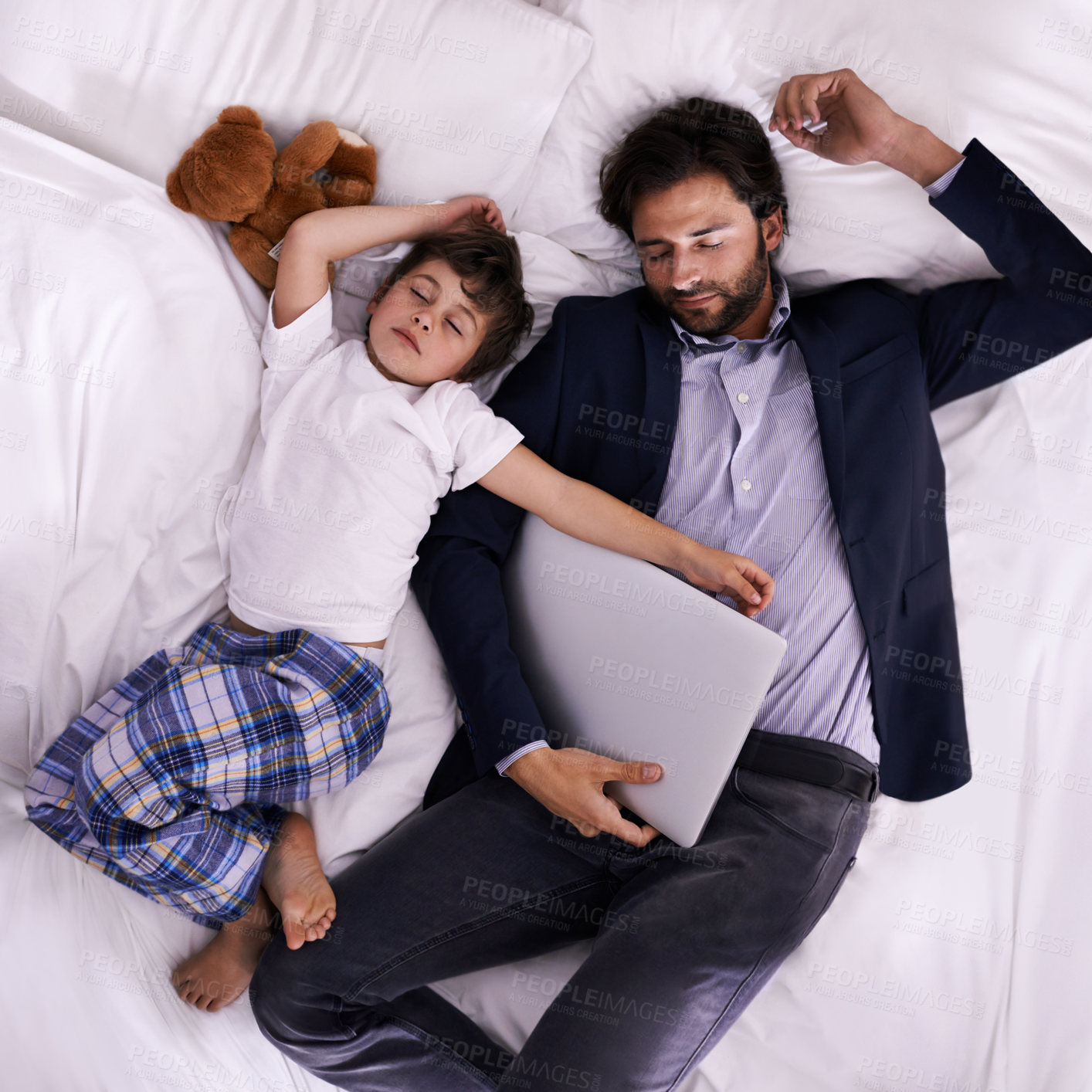 Buy stock photo Tired, businessman and sleep with son, laptop for rest with technology and suit. Father, child and bedroom with fatigue, love and above with freelance peace or remote work for stress management