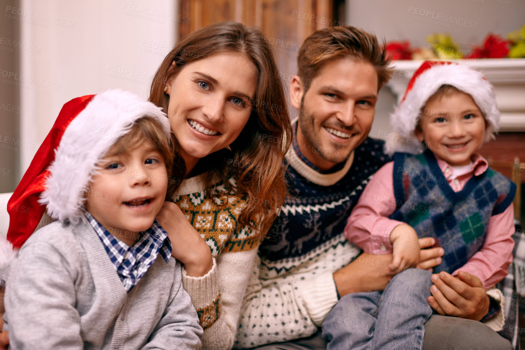 Buy stock photo Christmas, portrait and happy family in home for holiday or festive celebration in lounge. Xmas, parents and face of children with hats in living room, bonding and kids together at party in house