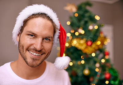 Buy stock photo Man, smile and hat for Christmas, portrait and house with bokeh on tree for festive celebration in holiday for season. Male person, happy and excited with joy on face to relax in home for break