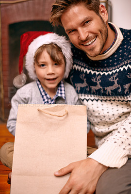 Buy stock photo Portrait, father and son with smile for Christmas gift in house, hat and boy with happiness for holiday. Man, relax and parent to child in apartment for celebration of festive season in home