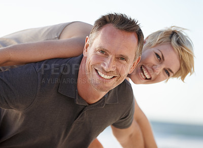 Buy stock photo Couple, portrait and smile outdoor with piggyback for bonding, honeymoon date and weekend holiday. Face, man and woman with embrace, happy and love getaway in nature for vacation, travel or adventure