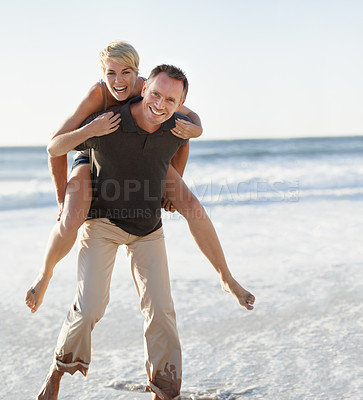 Buy stock photo Couple, portrait and happy on beach with piggyback for bonding, honeymoon date and weekend holiday. Face, man and woman with embrace, smile and love in water by sea for vacation, travel and adventure